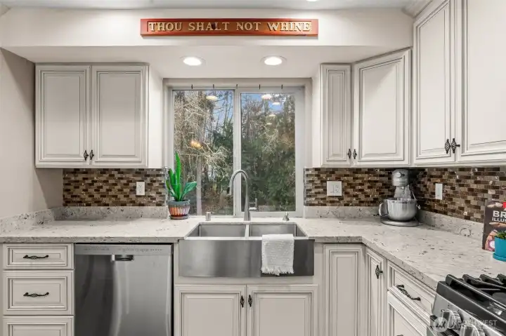 Updated in 2017, this farm style kitchen has updated tiling, can lights, countertops, farm sink, and more!