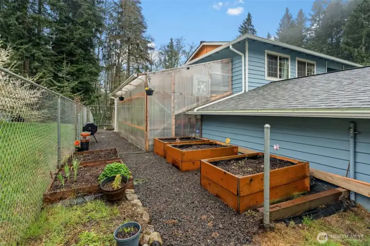 Those with a green thumb will greatly appreciate this tranquil garden space and large, organized greenhouse.