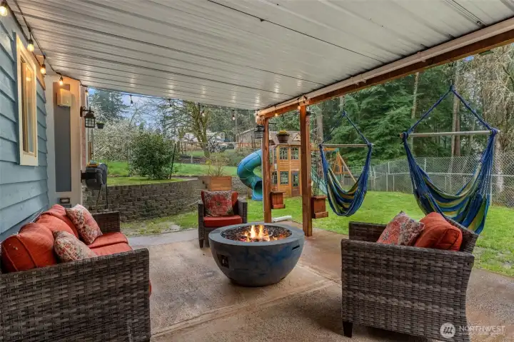 With access from the bottom floor and top deck, this covered patio space is perfect for evening gatherings and social company.