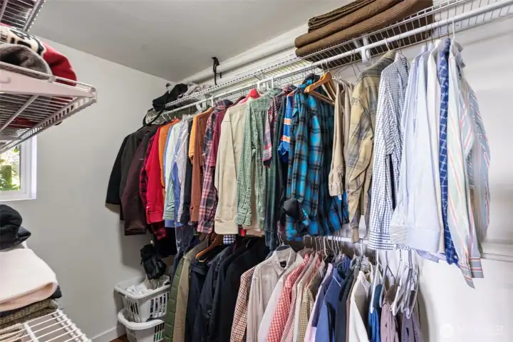Primary walk-in closet with adjustable shelving