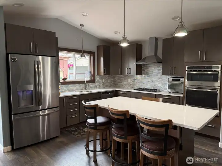 Kitchen completely updated, cabinets, appliances, flooring, added a large island and pendent lights along with all the lighting updated.