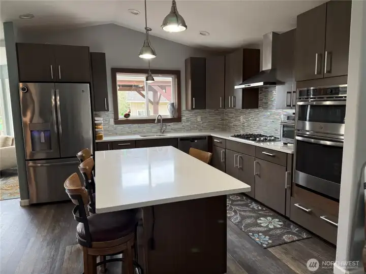 Easy care solid surface quartz countertops and tile backsplash.... all updated.