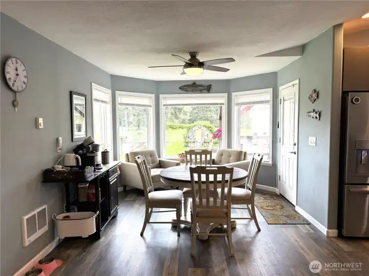 Dining area with beautiful bay window looking out at the garden area.