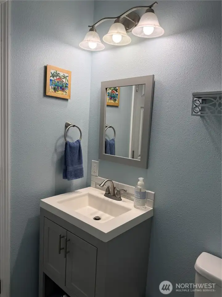 Half bath convenient to the kitchen. Newly added.