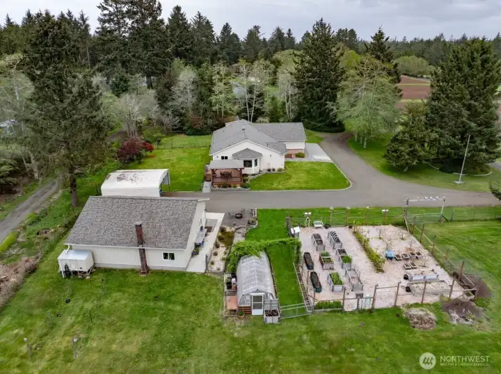Now let's look at all this property offers outside. Separate two car garage, large RV port, greenhouse and fenced raised bed garden with auto drip water line furnished by cistern behind the gargage.