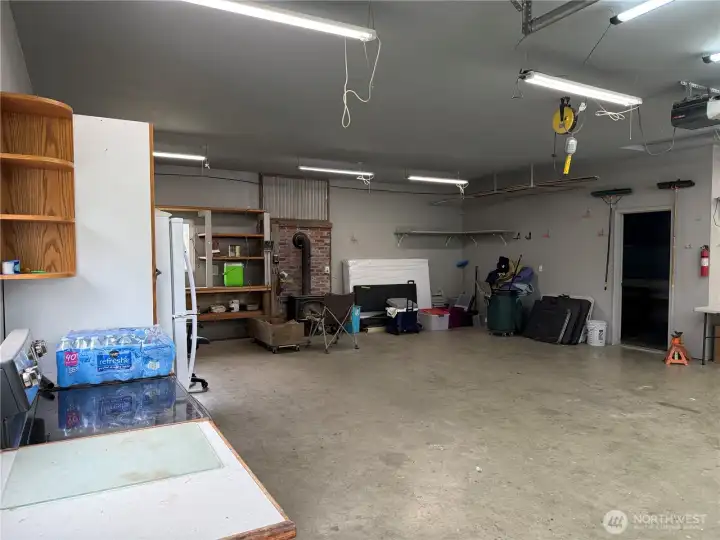 Use for vehicles or other purposes. Note a wood stove is at the back of the garage.