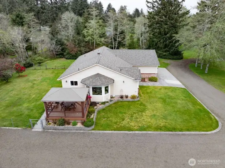 Looking at the house facing north, note the large, covered deck just off the dining area.
