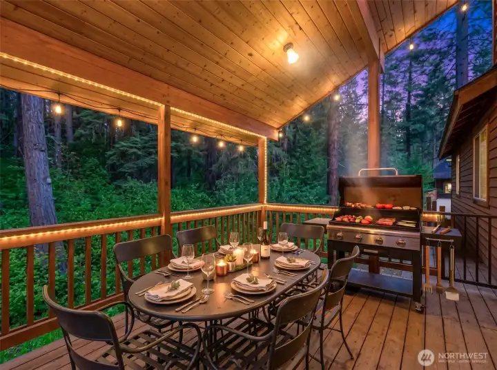 Designed for year-round enjoyment, the expansive outdoor living area offers space for dining, grilling, and relaxing while immersed in the tranquil forest setting.
