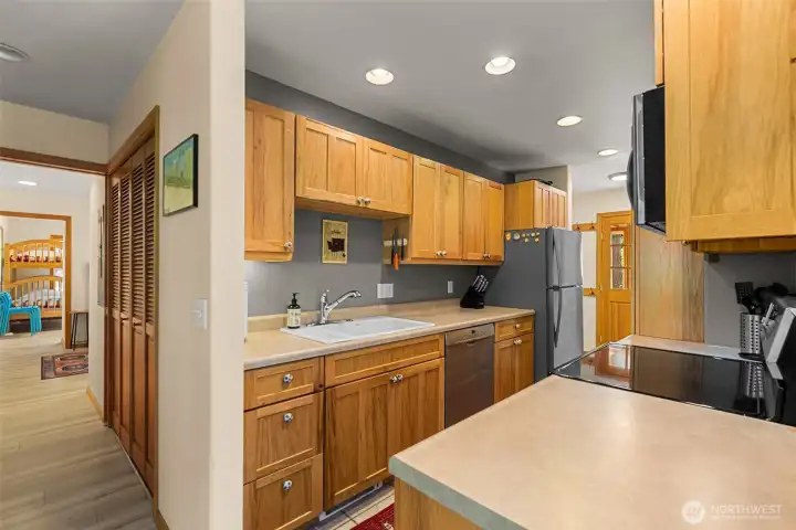 Efficiently designed kitchen featuring warm wood cabinetry, ample storage, and generous counter space for everyday living or hosting guests.