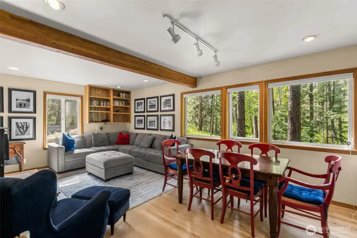 Large windows offering natural light, built in bookshelves, Wood beam accents