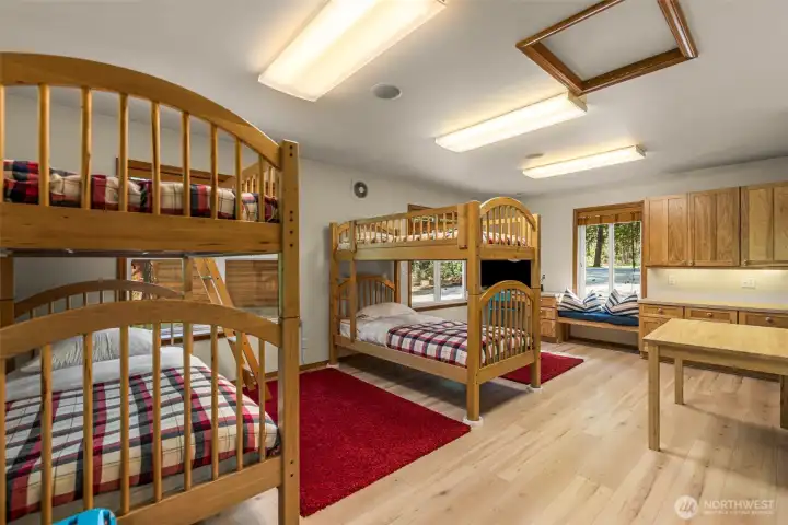Spacious bunk room designed to comfortably accommodate guests with multiple bunk beds, creating the ideal setup for vacation living or group gatherings