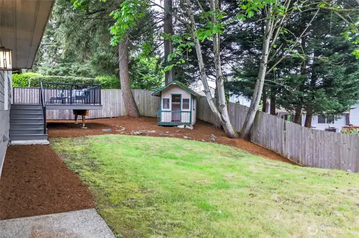 Fully fenced backyard with low maintenance composite deck.