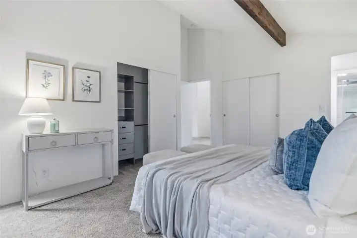 Primary bedroom with vaulted ceilings.