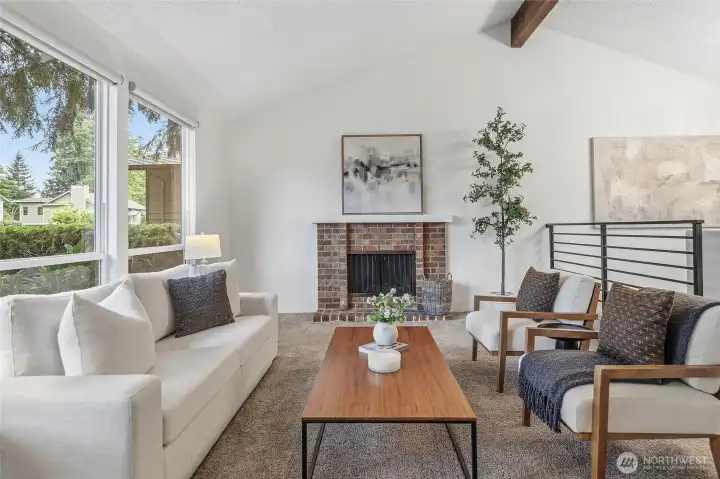 Living room with wood burning fireplace.