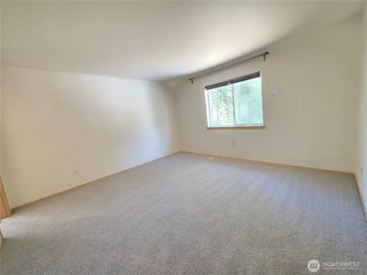 Main bedroom. New carpets and paint. Has view of the backyard.