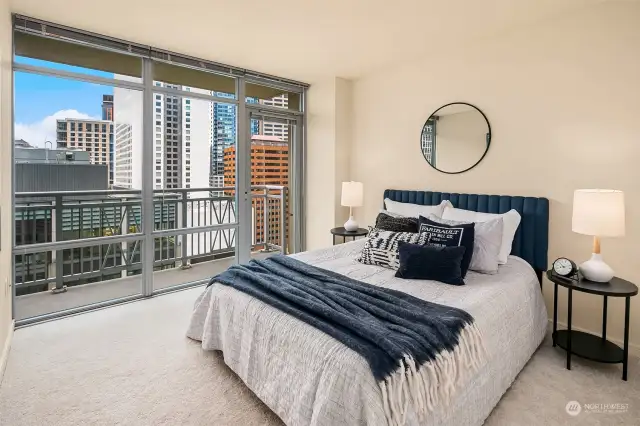 Spacious primary bedroom with large walk-in closet and private deck with city & territorial views
