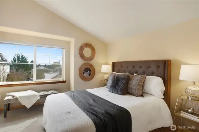 The primary bedroom, with its vaulted ceilings and territorial views does not dissapoint.