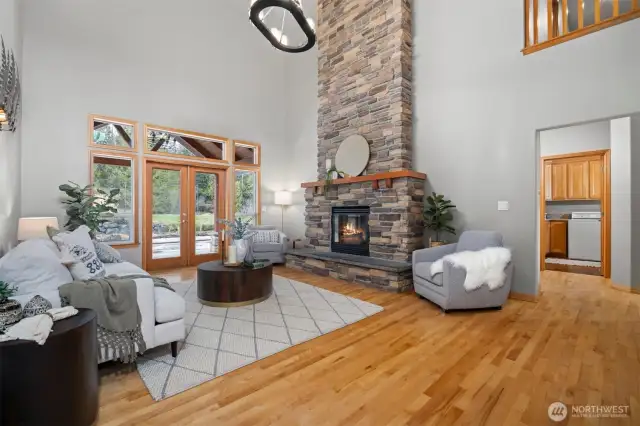French doors lead to covered outdoor living space and in ground pool.