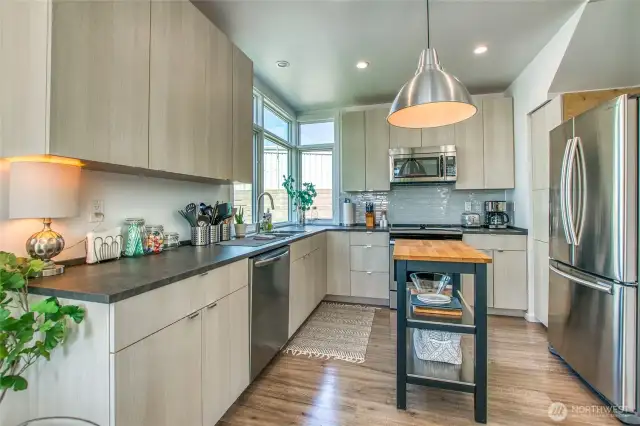 The clean, contemporary cabinetry and tile backsplash style are timeless.
