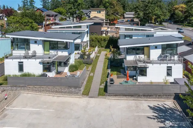 Each home in this small neighborhood is a separate tax parcel and shares a common parking lot and storage outbuilding.