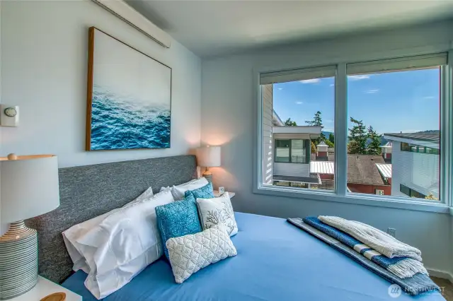 Southwest corner windows light up the second bedroom with a partial waterview of Fishing Bay.
