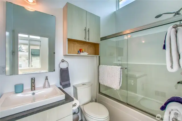 Vaulted windows provide for a bright full bath.