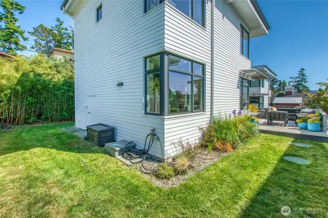 The yard wraps around the home with a bamboo privacy screening to the east.