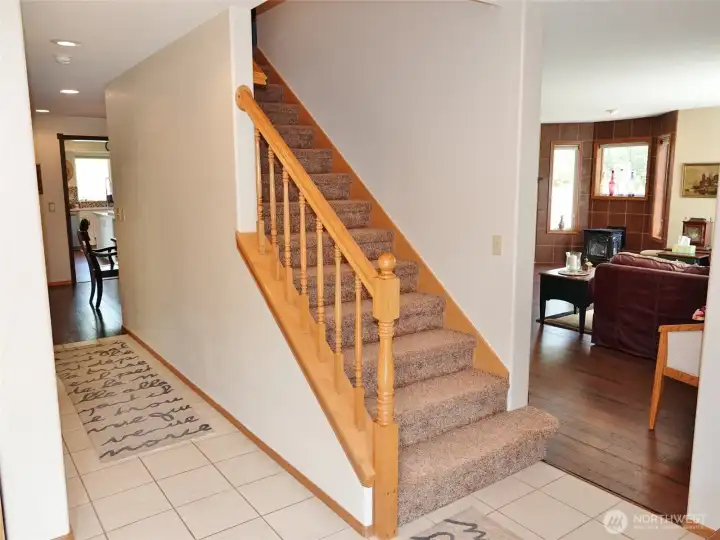 Entry and stairs leading to the upstairs with the Master Bedroom and Bathroom; Laundry Room; Guest Bathroom; (2) Bedrooms; Den; Bonus Room; and a huge Bedroom/Craft Room at the end of the house with a lot of windows for natural light.