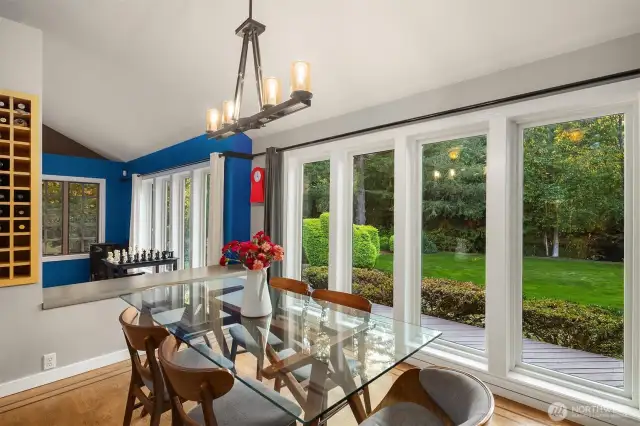 Dining overlooking expansive yard and Creek