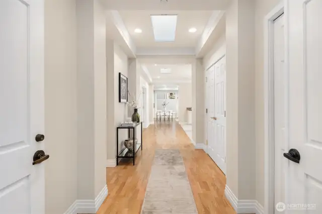Grand double door entry into the sunlit foyer of this penthouse unit