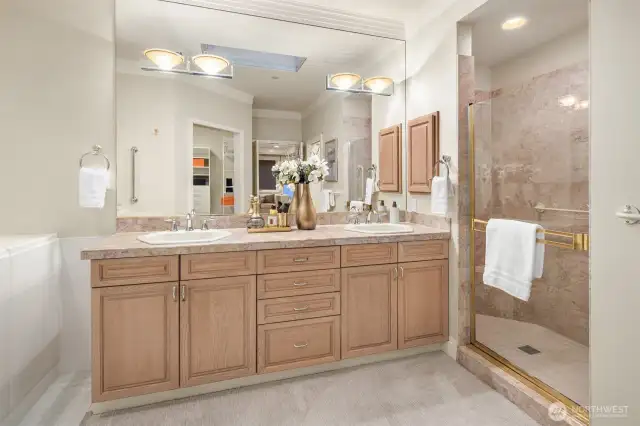 Primary bath features a double vanity, shower and walk-in tub