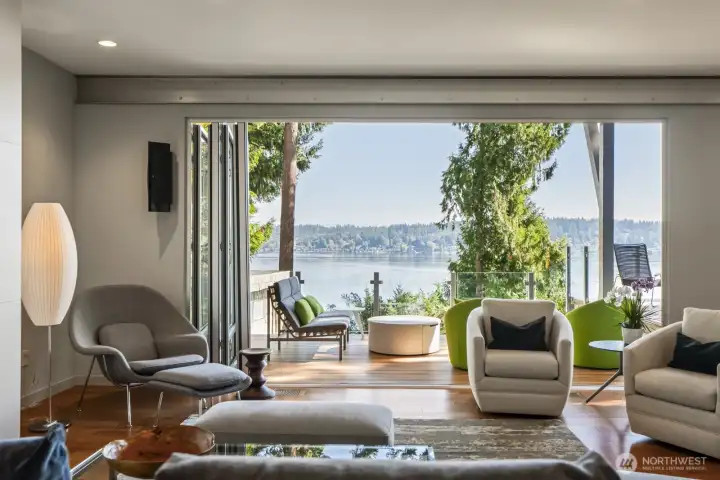 Walls of glass (Nana walls) open to lakeside decks designed for seamless indoor-outdoor living.