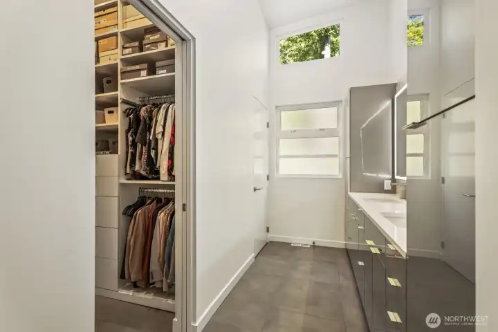 Primary bath with heated floors and adjacent walk in closet