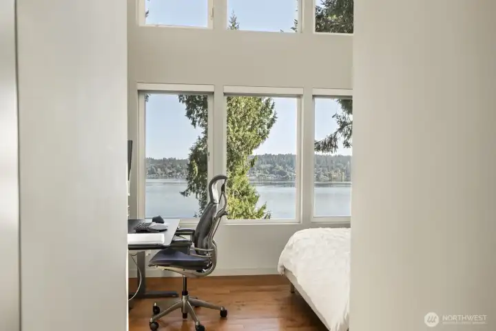 Second bedroom enjoys vaulted ceilings and floor to ceiling window wall to capture the incredible lake views.