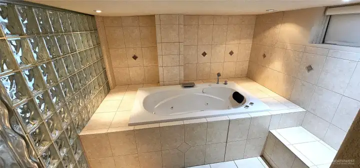 Luxurious jetted tub, large enough for 2, Step out onto heated floors.