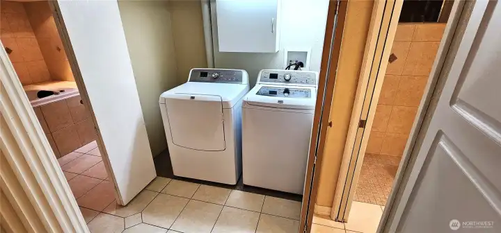Laundry area behind folding doors.