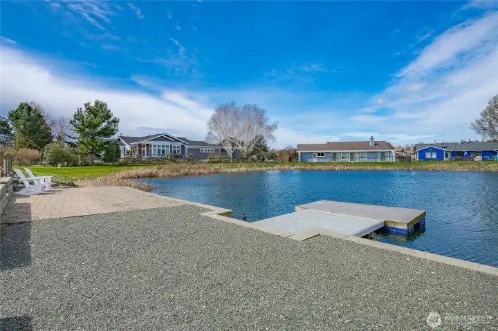 Looking toward the adjacent pathway leading to the Community rec area  just a 1 minute stroll away to tennis, pickleball, golf, heated pool & more!