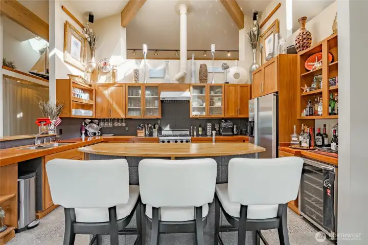 Stainless Appliances compliment the rich woods. Loads of creative storage!