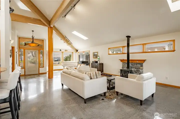 Gas free standing fireplace against a stone hearth provides comforting warmth when the Winter Inland Pacific seasons arrive.