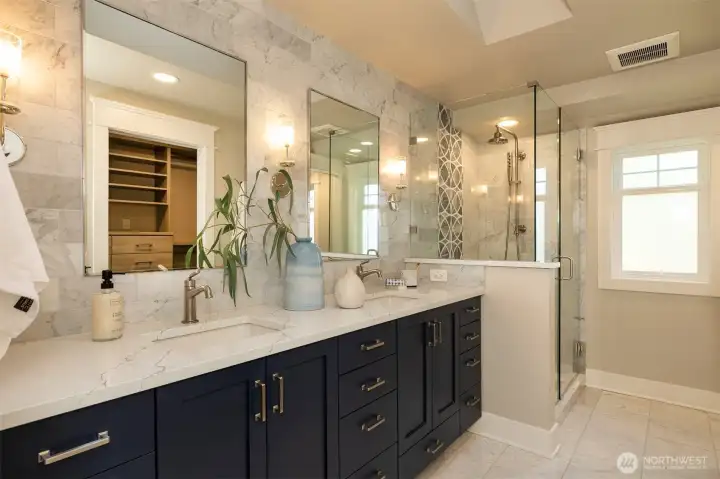 Primary bedroom has ensuite bath with dual vanity and gorgeous tile.