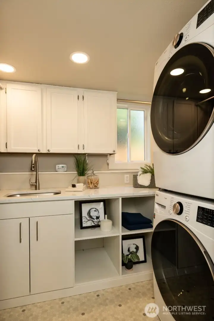 Laundry room with storage space.