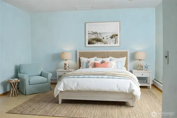 The lower-level bedroom offers a peaceful, coastal-inspired space with light flooring and a comfortable layout.