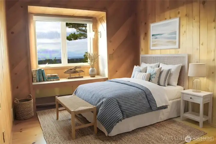 The upstairs primary bedroom offers a warm, wood-lined retreat with a cozy layout and beautiful ocean views from the large window.