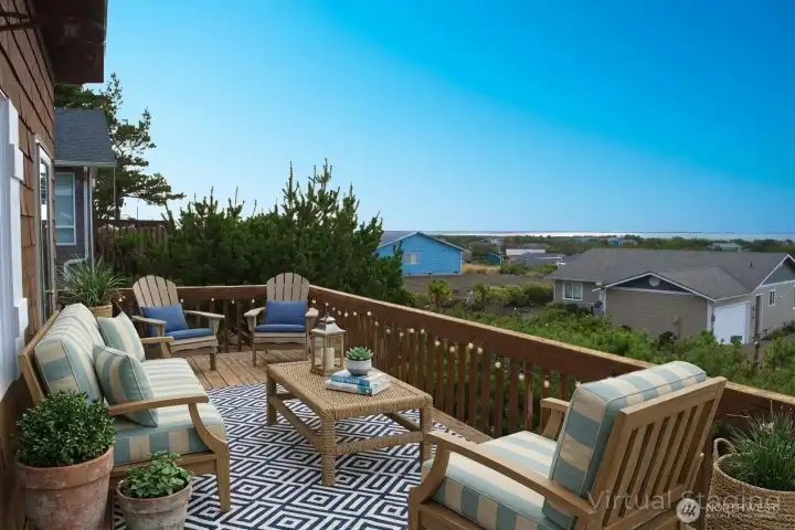 The upstairs deck offers a spacious outdoor retreat for comfortable seating and sweeping ocean views.