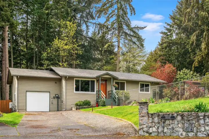 The 1,040 square foot home is situated on a 1/4 acre lot. Surrounded by lush lawns, gardens, and adjacent to a green belt.