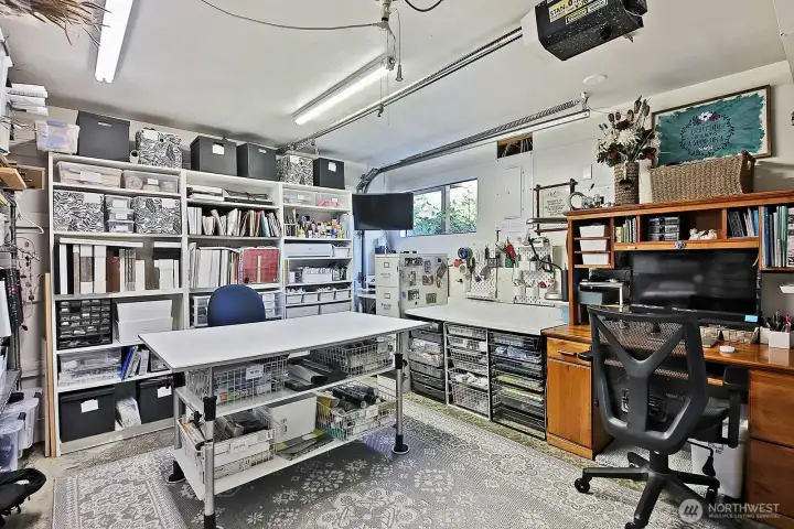 original garage on lower level of main home currently used as craft room, 2nd laundry area and bath adjacent to this room