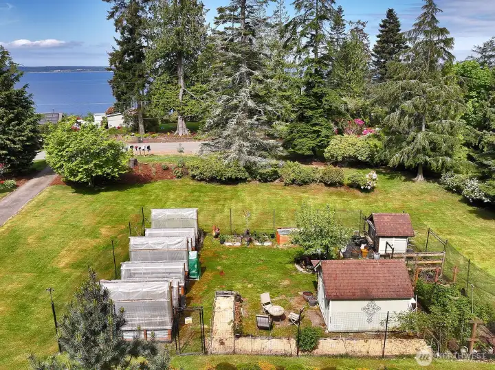 large fenced garden area with shed and chicken coop