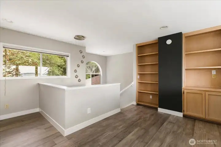Loft with plenty of built-in cabinets, makes for a