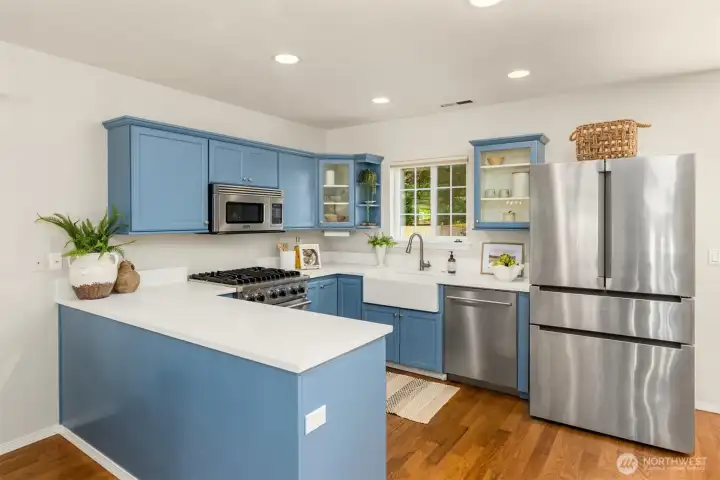 The kitchen is newer with quartz counters and solid wood cabinetry. The kitchen is newer with quartz counters and solid wood cabinetry.
