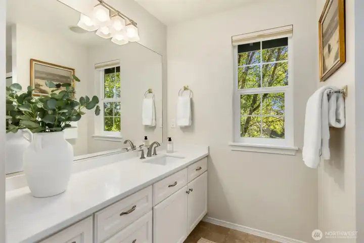 The en-suite primary bath overlooking the back yard. The en-suite primary bath overlooking the back yard.